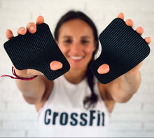 Load image into Gallery viewer, Person wearing a 'CrossFit' shirt holding black Monkey Grips against a light background